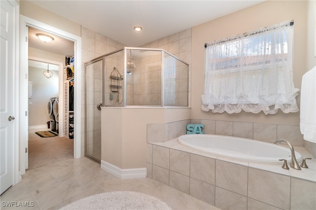 bathroom with shower with separate bathtub and tile patterned floors