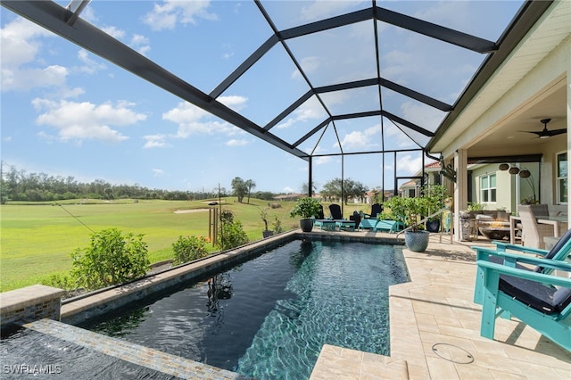 view of pool featuring outdoor lounge area, glass enclosure, ceiling fan, and a patio