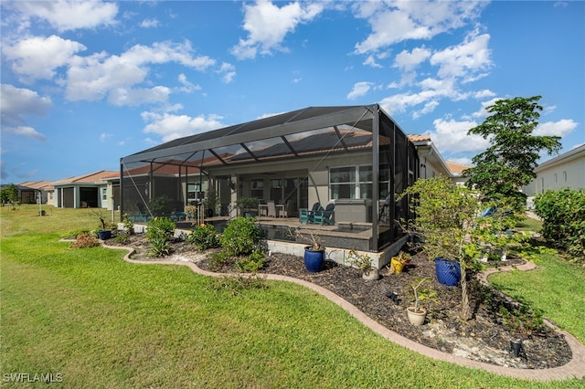 back of property featuring glass enclosure and a yard