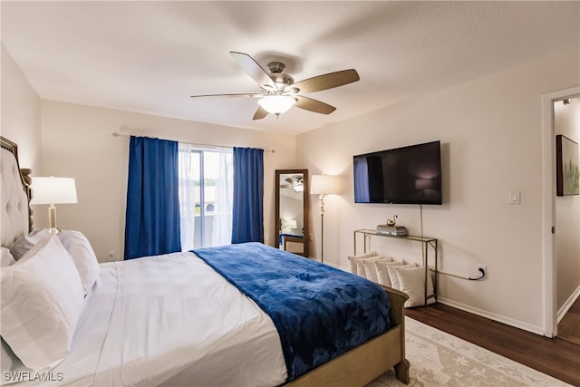 bedroom featuring ceiling fan and dark hardwood / wood-style floors