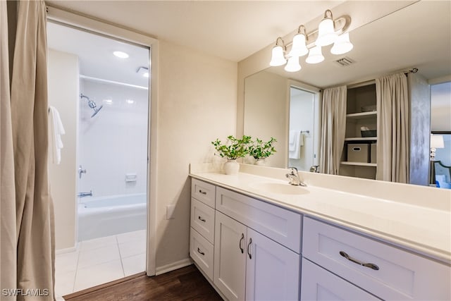 bathroom featuring vanity, hardwood / wood-style flooring, and shower / bathtub combination with curtain