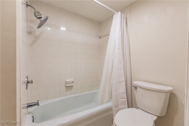 bathroom featuring shower / bath combo and toilet