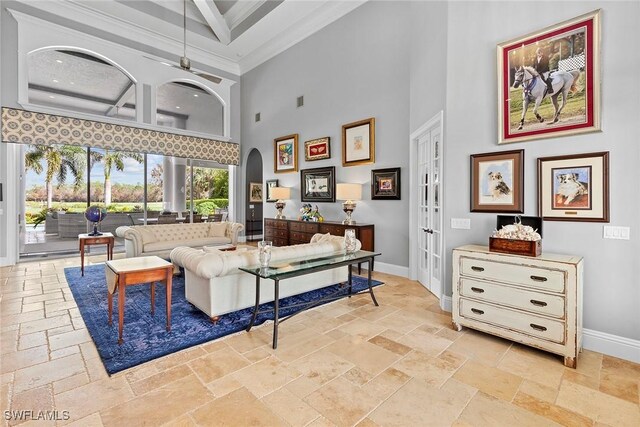 living room featuring coffered ceiling, french doors, crown molding, a towering ceiling, and beamed ceiling