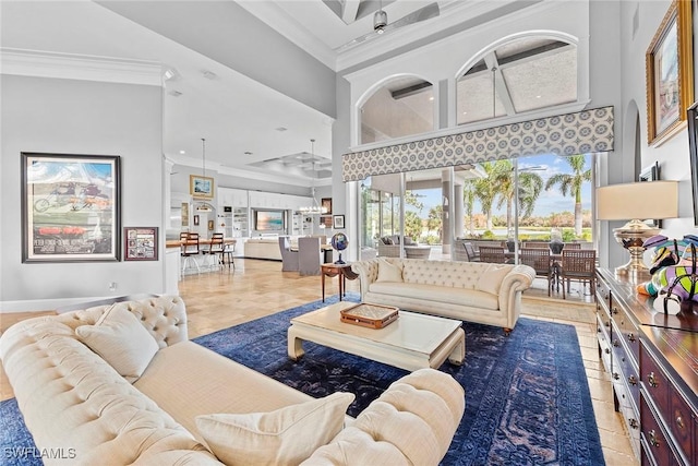 living room with a high ceiling and ornamental molding