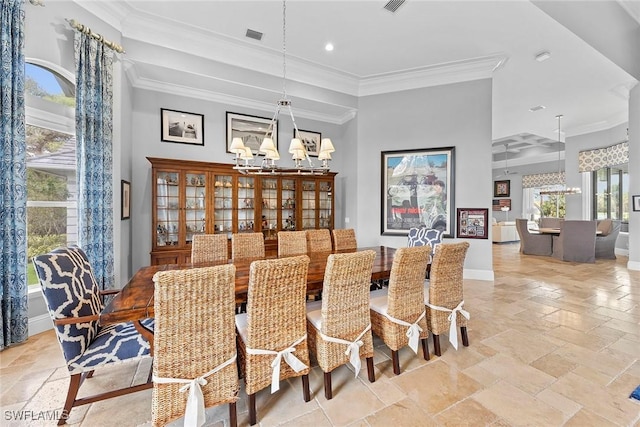 dining space featuring ornamental molding, a towering ceiling, and a notable chandelier