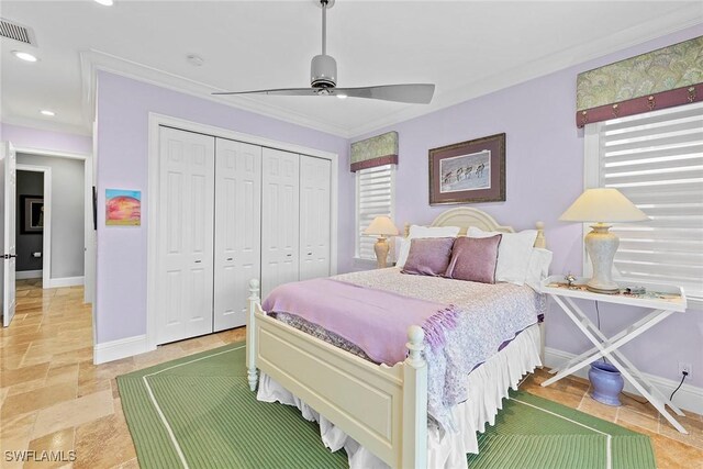 bedroom with ceiling fan, ornamental molding, and a closet