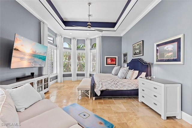 bedroom with a raised ceiling and crown molding