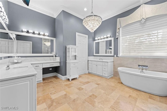 bathroom with vanity, ornamental molding, a bath, and a chandelier