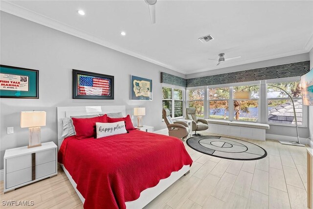 bedroom with crown molding and light hardwood / wood-style floors