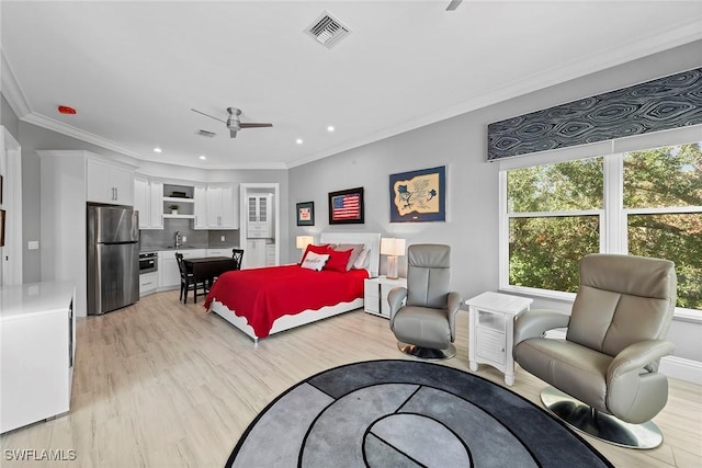 bedroom with ornamental molding, sink, stainless steel fridge, and light hardwood / wood-style flooring