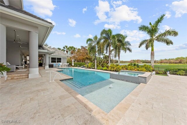 view of pool featuring ceiling fan, a patio area, and an in ground hot tub