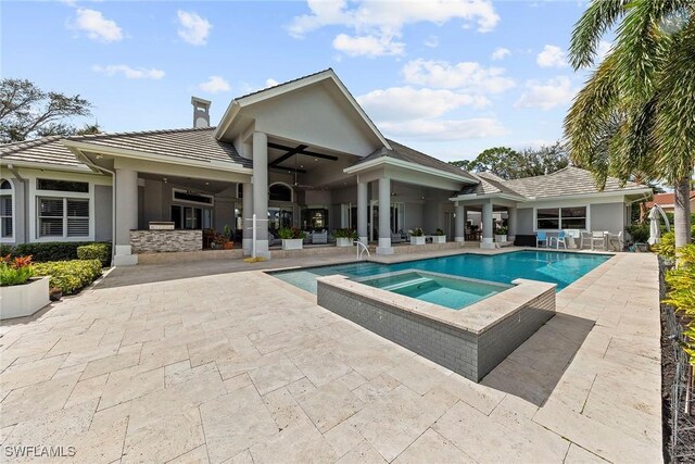 view of pool featuring ceiling fan, a patio area, and an in ground hot tub