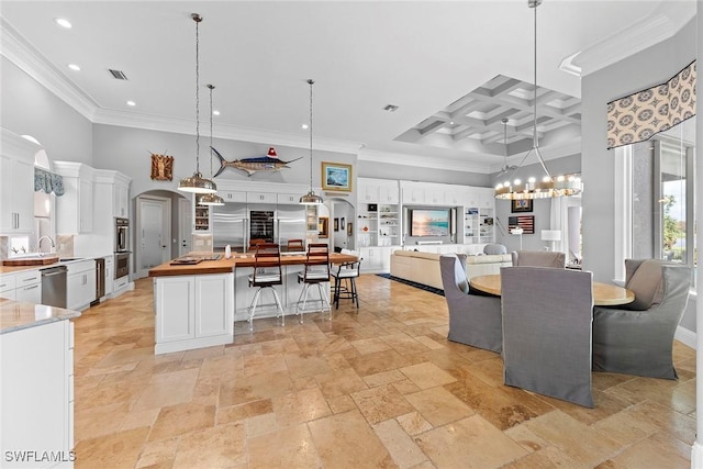 dining room featuring crown molding, beamed ceiling, a high ceiling, and coffered ceiling