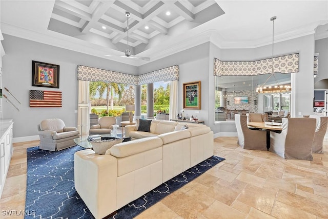 living room with a towering ceiling, crown molding, ceiling fan, and coffered ceiling