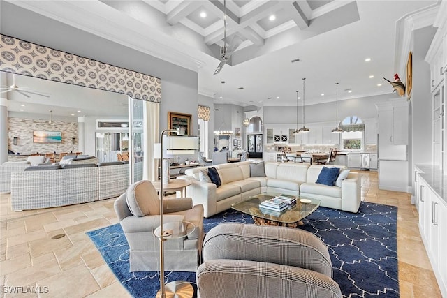 living room featuring coffered ceiling, ceiling fan, a towering ceiling, ornamental molding, and beamed ceiling