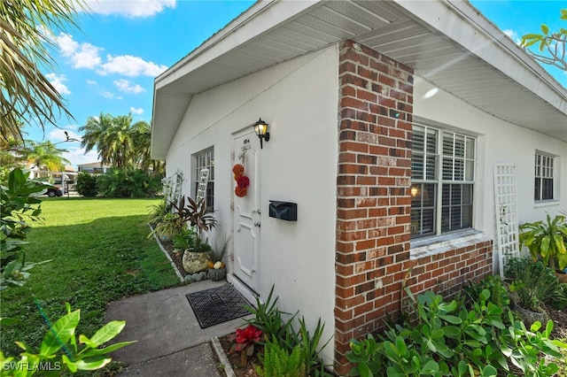 view of side of home with a yard