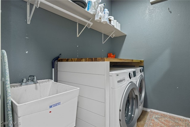 321 Shadow Lakes Dr, Lehigh Acres, FL 33974 - washroom featuring washing machine and clothes dryer, baseboards, a sink, and laundry area