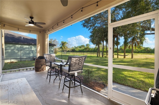 sunroom / solarium featuring ceiling fan