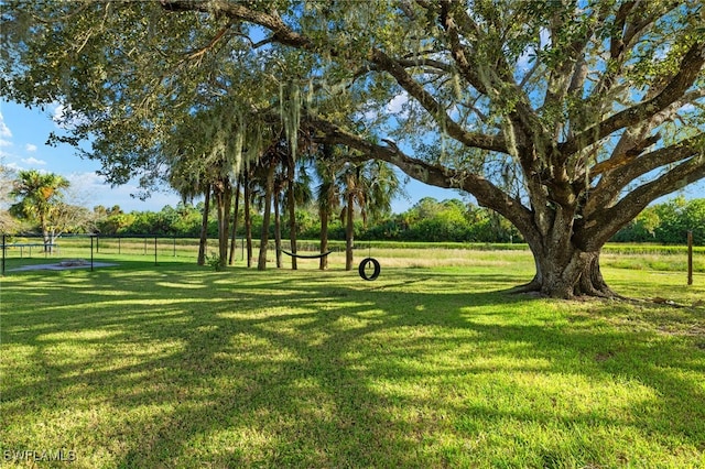 321 Shadow Lakes Dr, Lehigh Acres, FL 33974 - view of home's community with fence and a yard