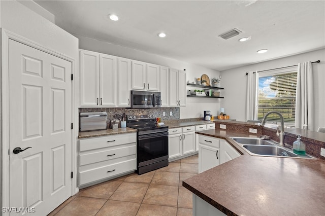 kitchen featuring appliances with stainless steel finishes, backsplash, sink, white cabinets, and light tile patterned flooring