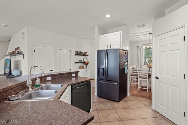 321 Shadow Lakes Dr, Lehigh Acres, FL 33974 - kitchen featuring black appliances, dark countertops, a sink, and white cabinets