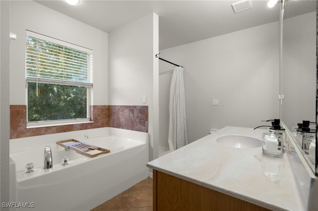 bathroom with tile patterned flooring, vanity, and independent shower and bath