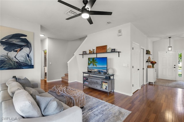 living room with ceiling fan and dark hardwood / wood-style flooring