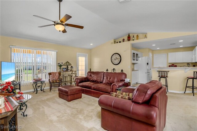 carpeted living room with a wealth of natural light, ceiling fan, and lofted ceiling