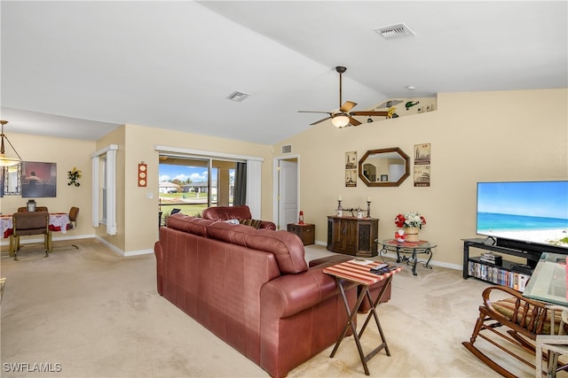 carpeted living room with ceiling fan and lofted ceiling