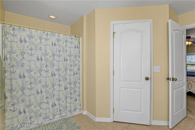 bathroom featuring a shower with curtain, tile patterned floors, and ceiling fan