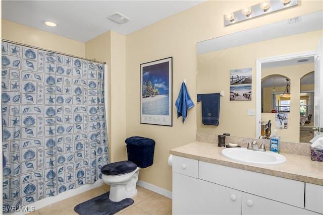 bathroom with vanity, tile patterned flooring, and toilet