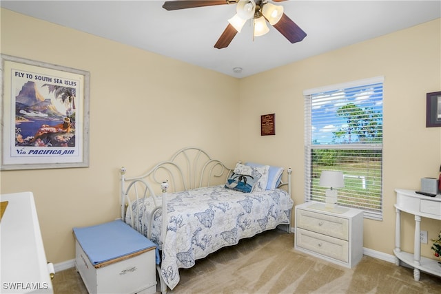 bedroom featuring ceiling fan and carpet