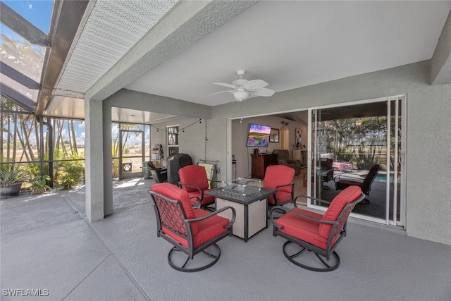 view of patio featuring glass enclosure and ceiling fan