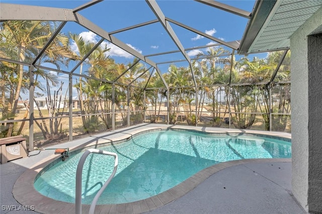 view of swimming pool featuring a lanai and a patio area