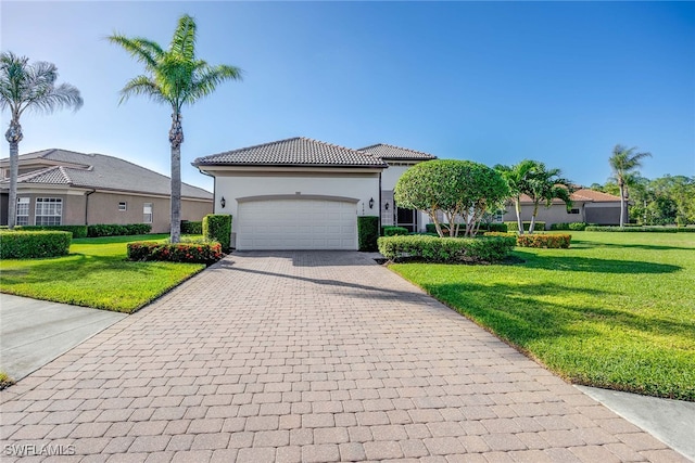 view of front of home with a garage and a front lawn