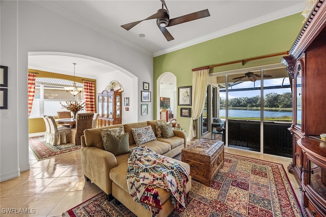 tiled living room with ceiling fan with notable chandelier, a healthy amount of sunlight, a water view, and crown molding