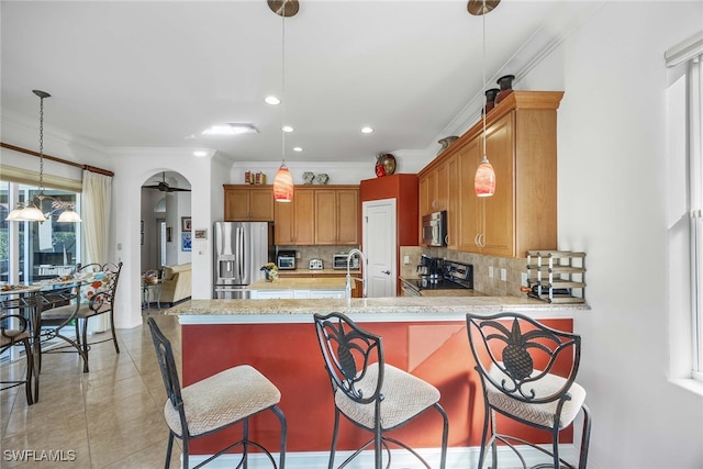 kitchen featuring backsplash, kitchen peninsula, ornamental molding, and stainless steel appliances