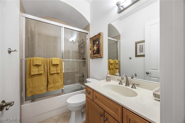 full bathroom with tile patterned flooring, vanity, toilet, and enclosed tub / shower combo