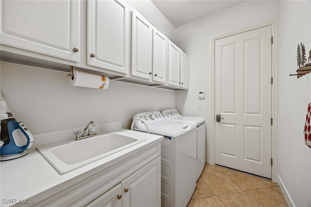 clothes washing area featuring cabinets, light tile patterned floors, washer and clothes dryer, and sink