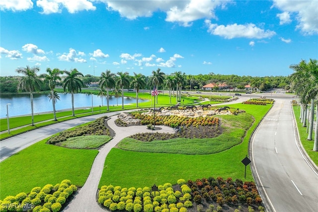 view of community featuring a lawn and a water view