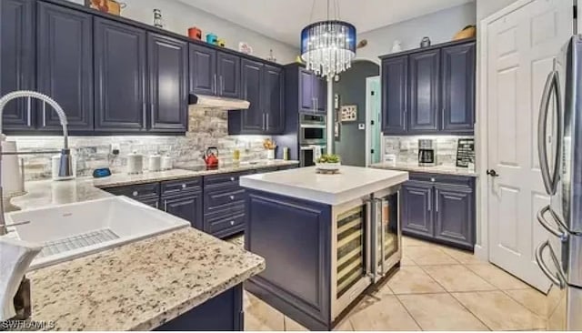 kitchen featuring a center island, decorative light fixtures, backsplash, and stainless steel appliances