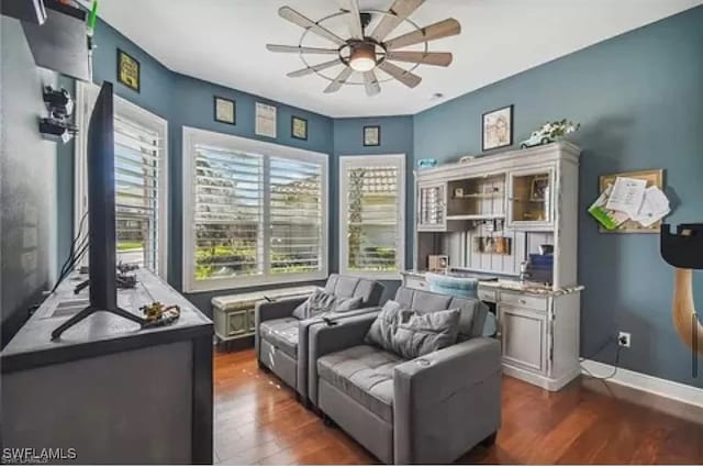 sitting room featuring dark hardwood / wood-style floors and ceiling fan