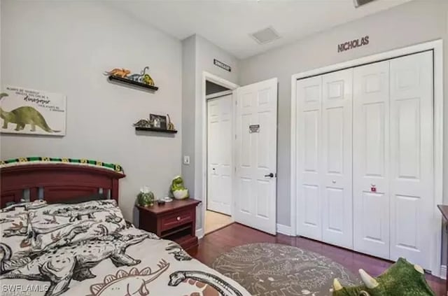 bedroom featuring dark hardwood / wood-style floors and a closet