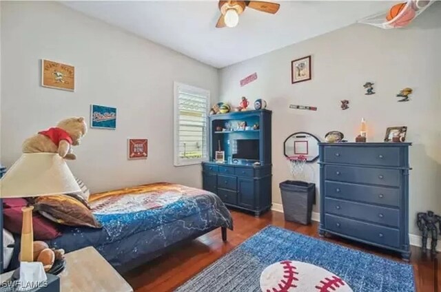 bedroom with dark wood-type flooring and ceiling fan