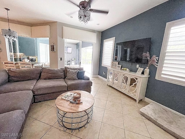 tiled living room with ceiling fan and a wealth of natural light