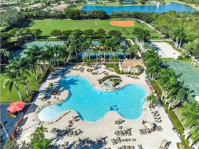 view of pool with a water view and a patio area