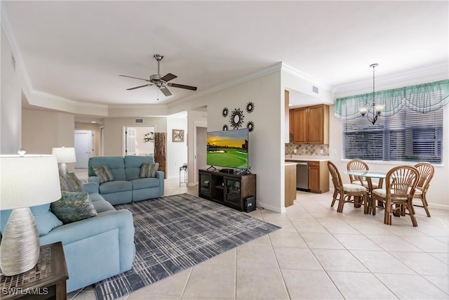 tiled living room with ceiling fan with notable chandelier and crown molding