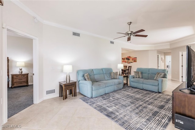 living room featuring ceiling fan, light tile patterned floors, and crown molding