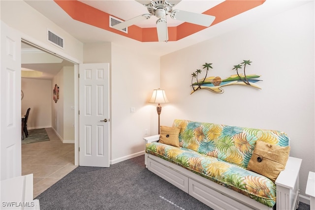 sitting room with ceiling fan and tile patterned flooring