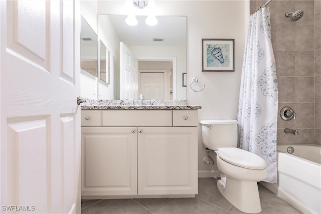 full bathroom with shower / bath combo with shower curtain, tile patterned floors, toilet, and vanity